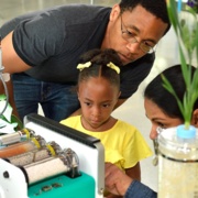 Dad and daughter with scientist